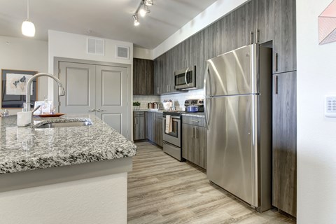 a kitchen with stainless steel appliances and a granite counter top