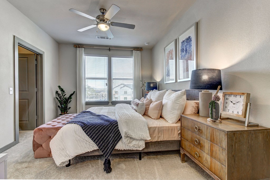 a bedroom with a bed and a ceiling fan
