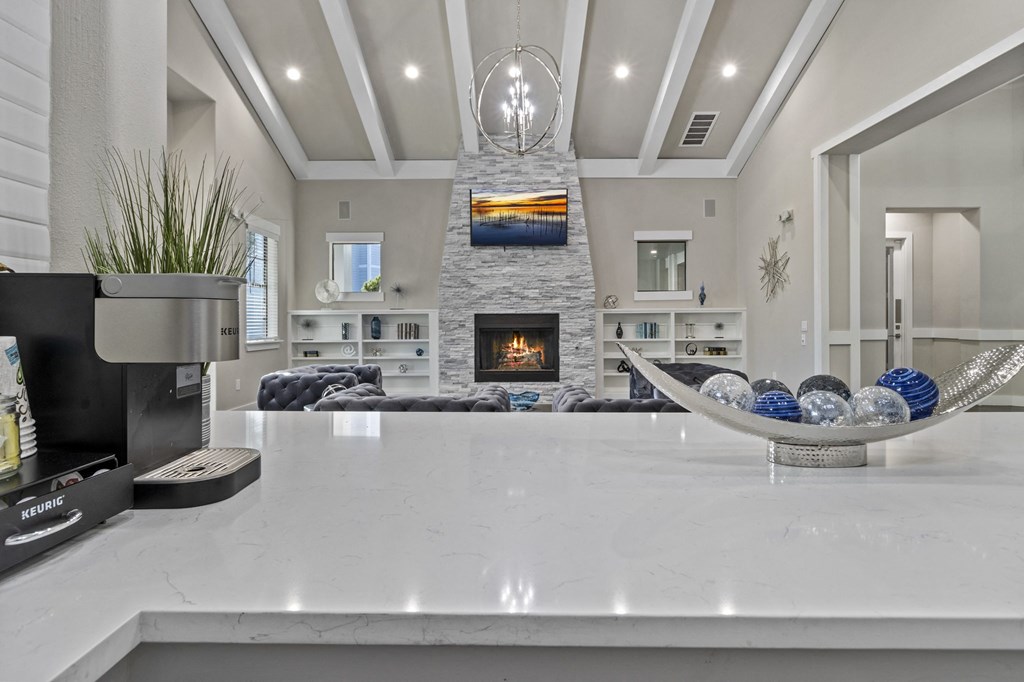 a large kitchen with a fireplace and a large counter top