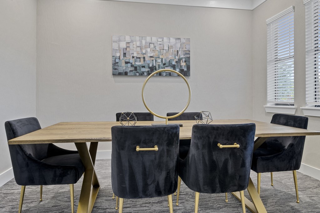 a dining room with a wooden table and four black chairs