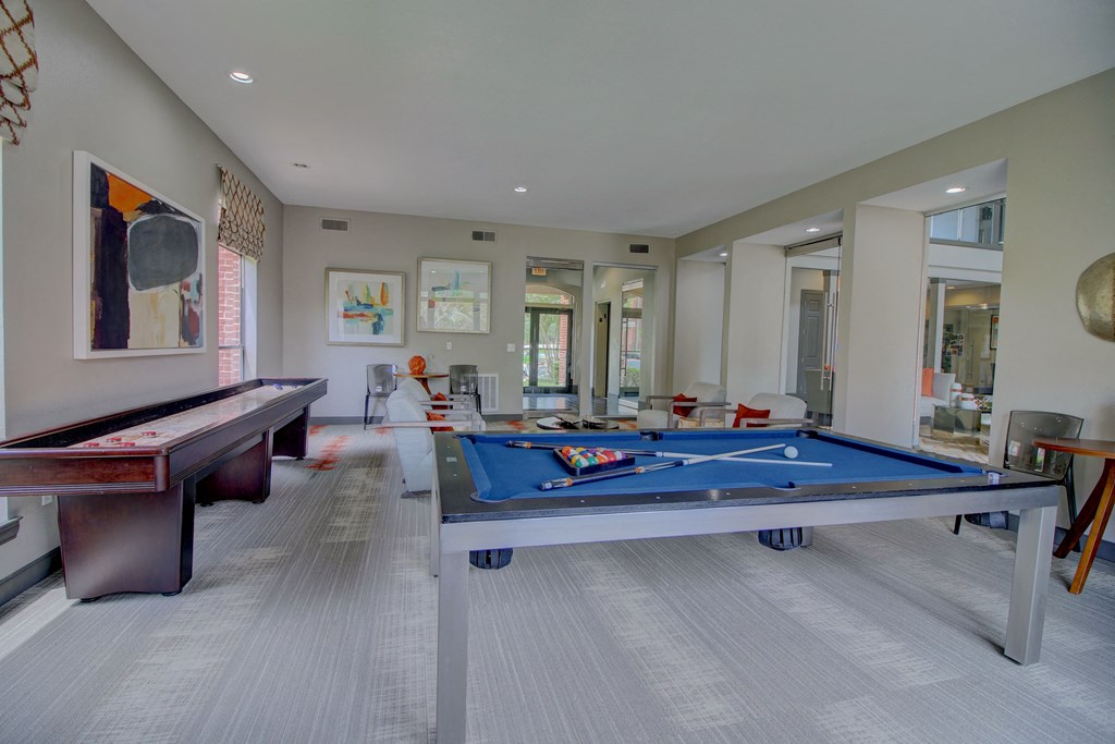 a games room with a pool table and ping pong table
