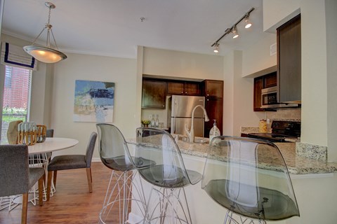 a kitchen and dining room with a glass table and chairs