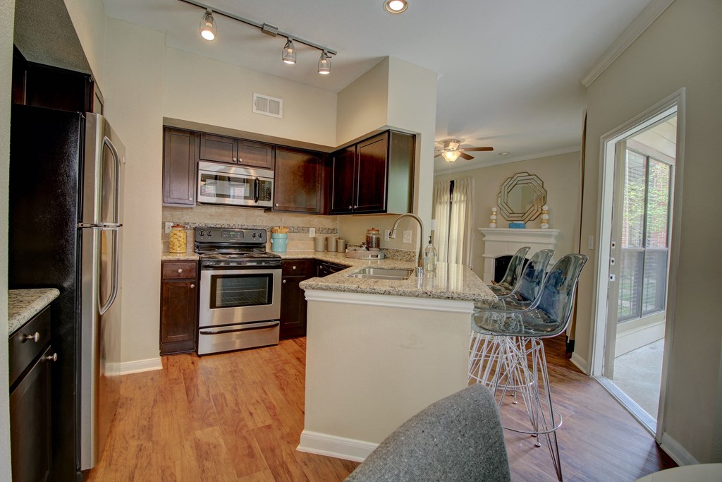 a kitchen with a breakfast bar and a fireplace