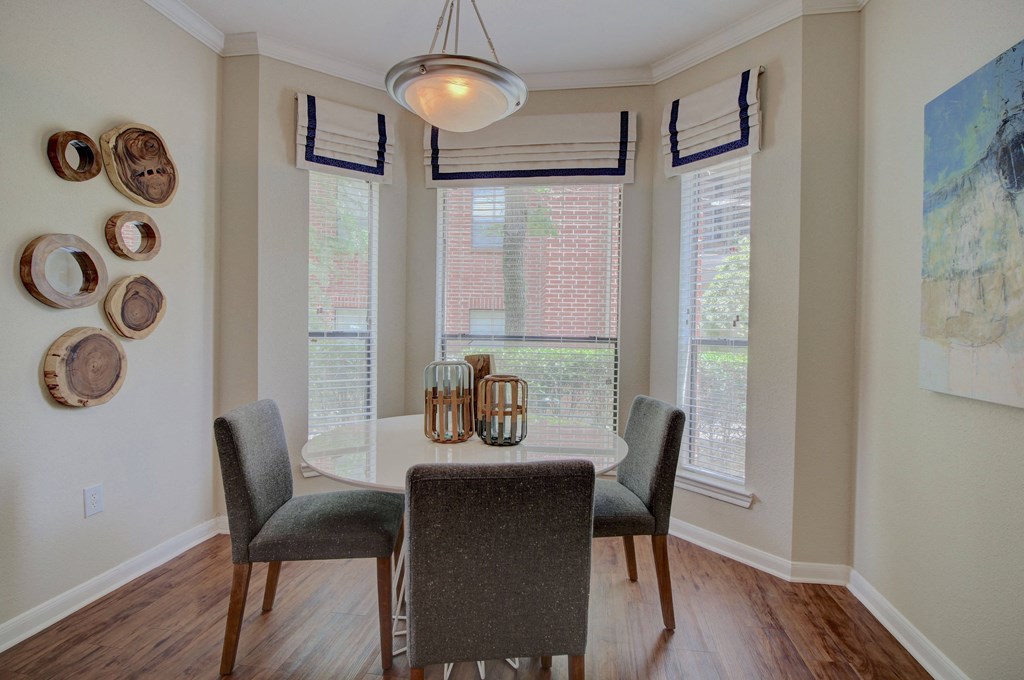 a dining room with a table and chairs