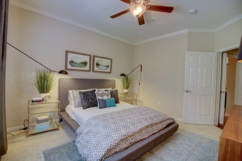 a bedroom with a bed and a ceiling fan