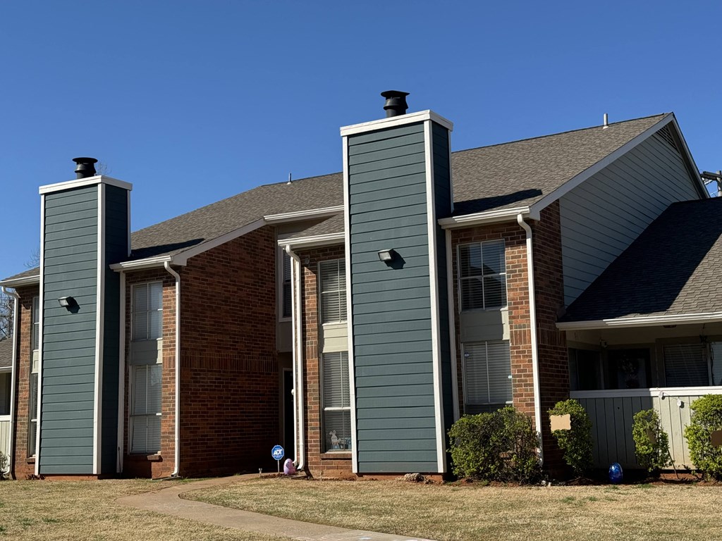 a building with two chimneys on the side of it