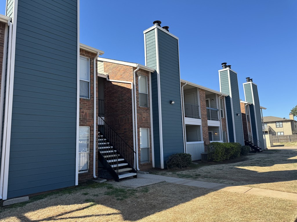 an image of a row of apartment buildings with stairs