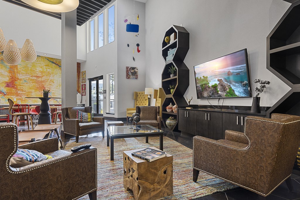 a living room with couches and chairs and a television