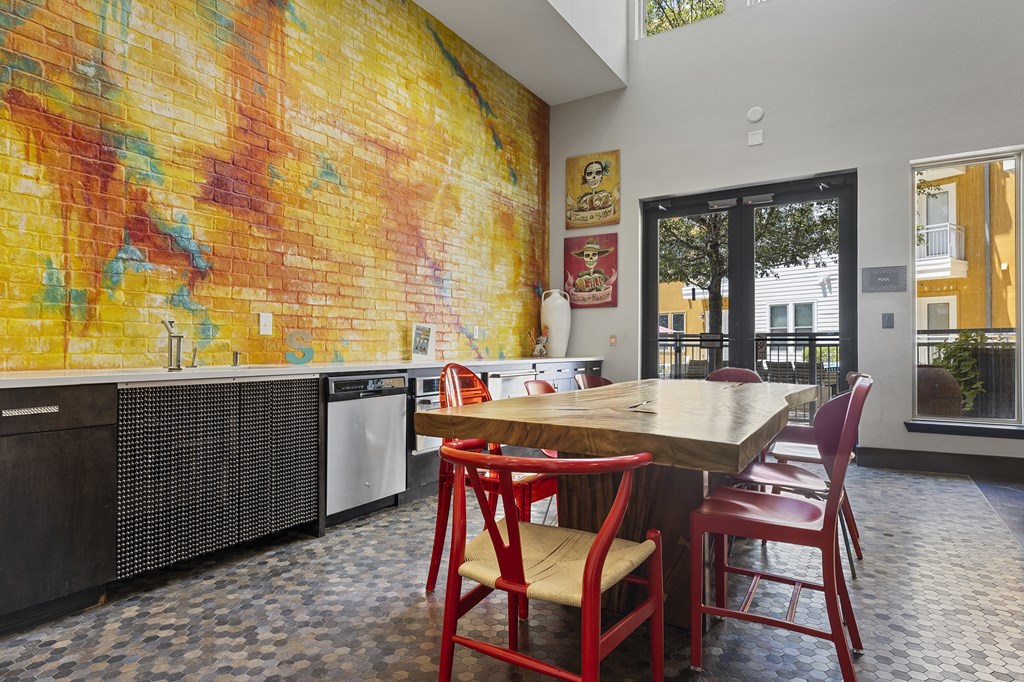 a kitchen with a table and chairs and a mural on the wall