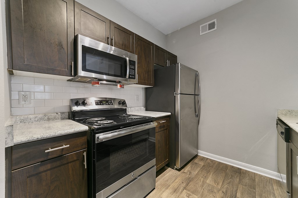 a kitchen with stainless steel appliances and a stainless steel refrigerator