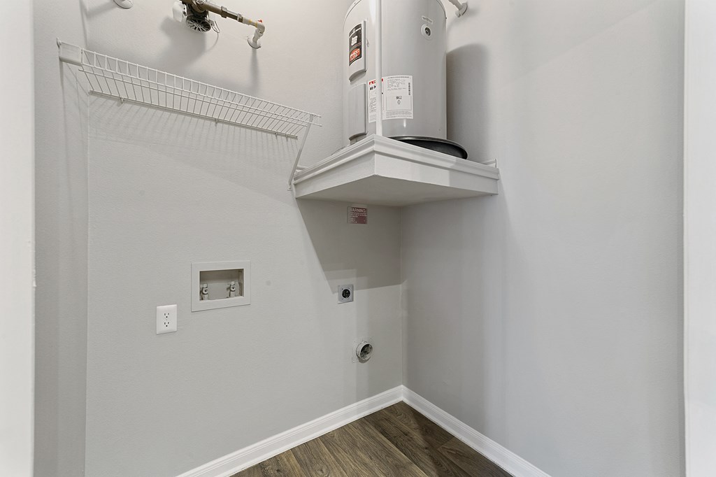 the upstairs laundry room is equipped with a washer and dryer and a shelf
