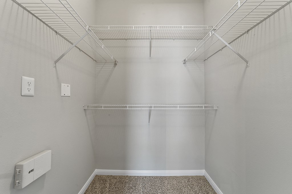 the spacious walk in closet at the whispering winds apartments in pearland tx