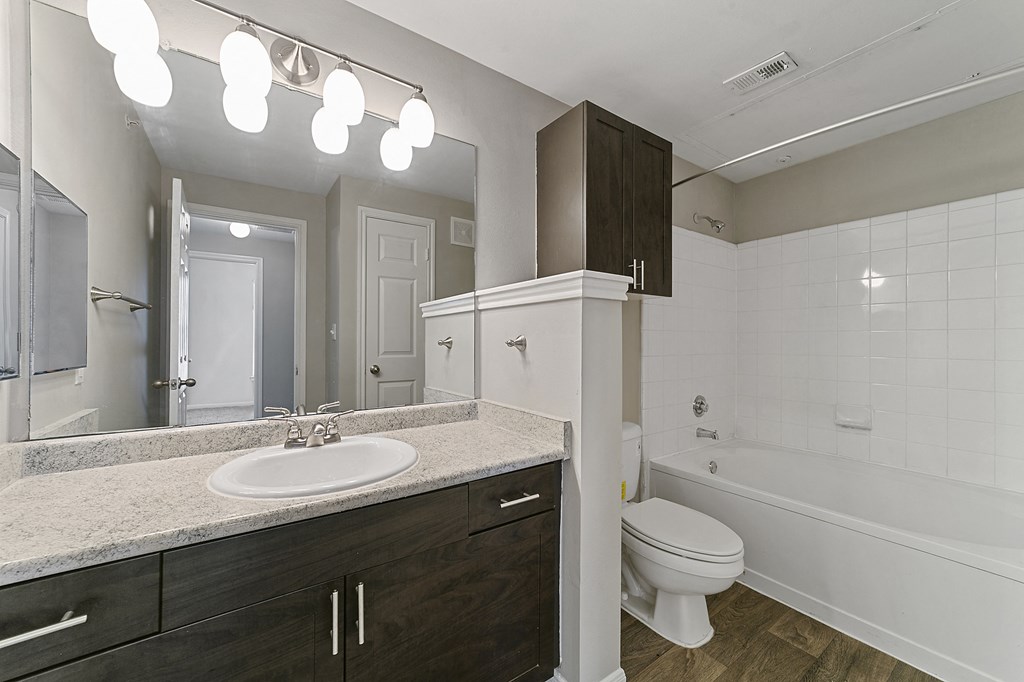 a bathroom with a toilet sink and a mirror