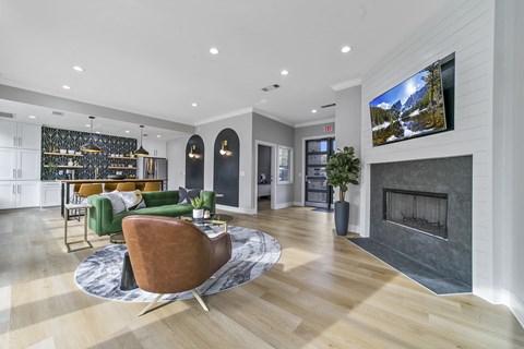 a living room with a fireplace and a table and chairs