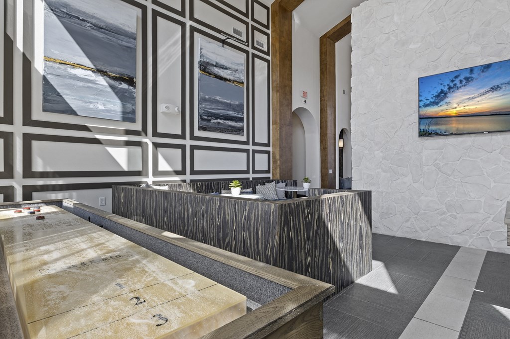 the lobby of a hotel with a reception desk and pictures on the wall