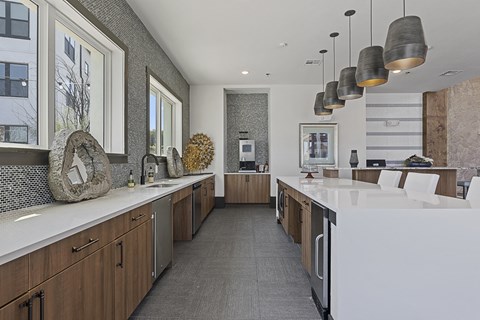 a large kitchen with a large white counter top and a large island