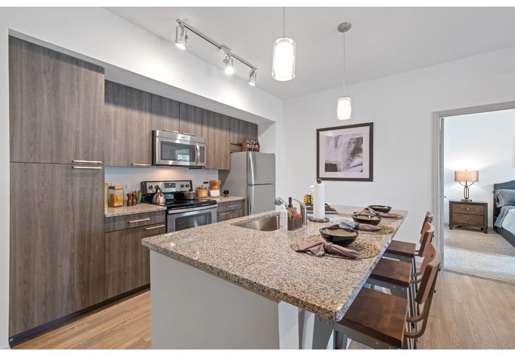 a kitchen with a granite counter top and a dining room table