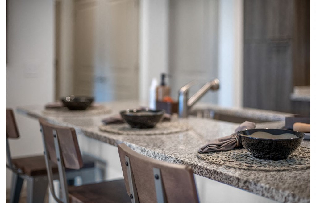 a kitchen with a counter top with bowls on it