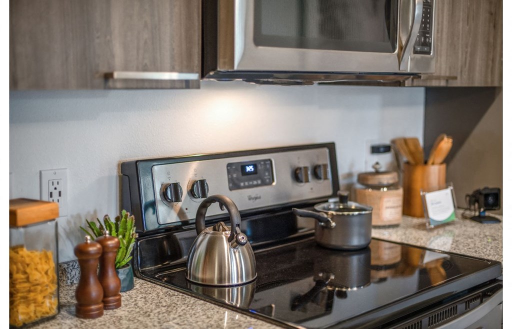 a kitchen with a stove and a kettle on the stove