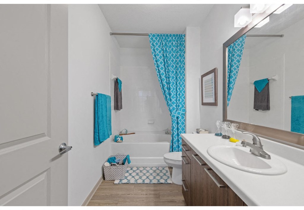 a bathroom with a sink and a shower and a toilet