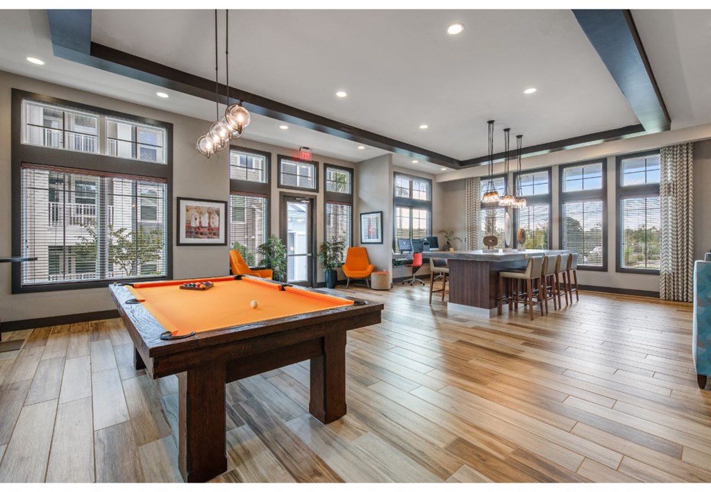 a game room with a pool table and a bar