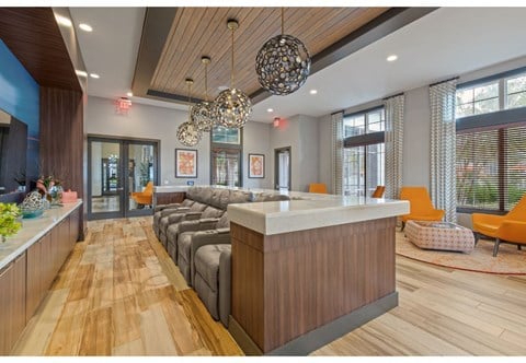 a living room with a long couch and a counter top