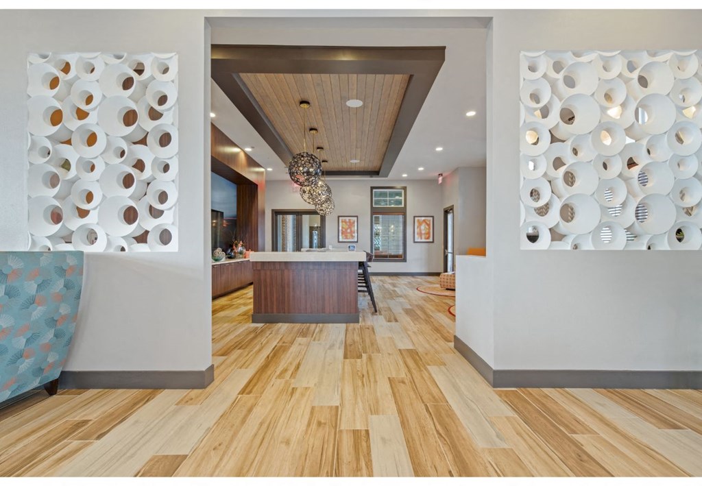 a view of a dining room and a kitchen with plates on the wall