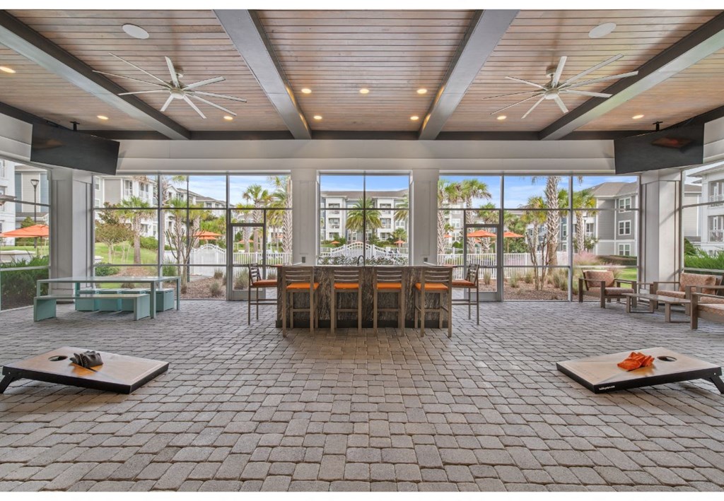 a large gathering room with a large table and chairs and windows