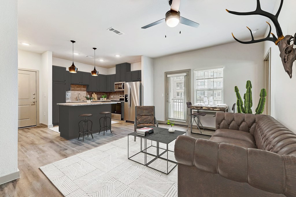 a living room and kitchen with a couch and a table