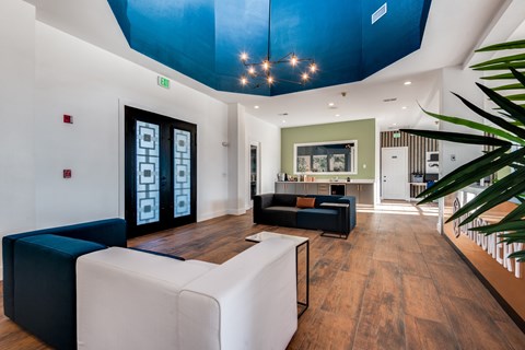 A modern living room with a white sofa and a black and white coffee table.