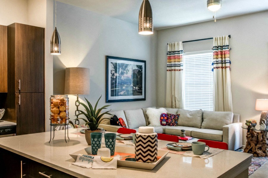 a living room and kitchen with a couch and a table