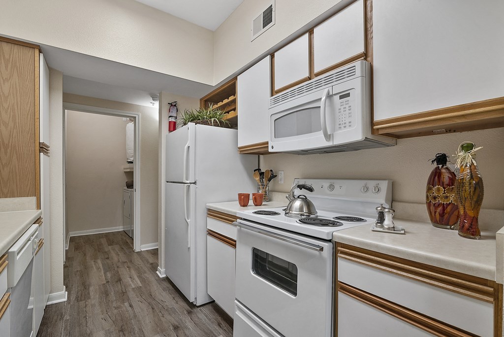 a kitchen with white appliances and a white refrigerator