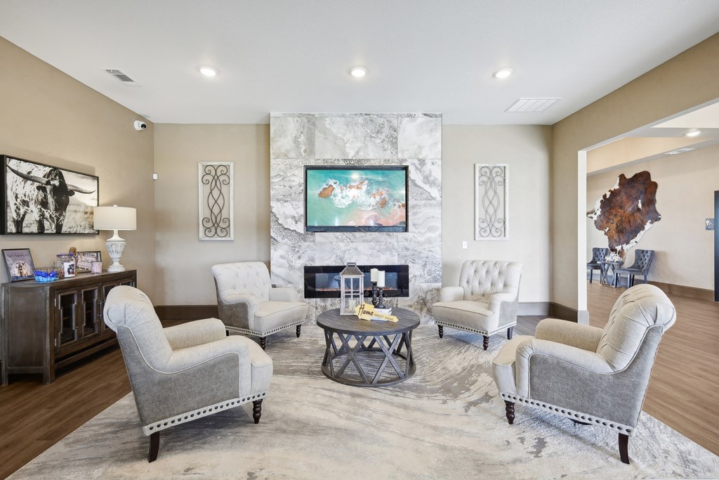 a living room with couches and chairs and a fireplace