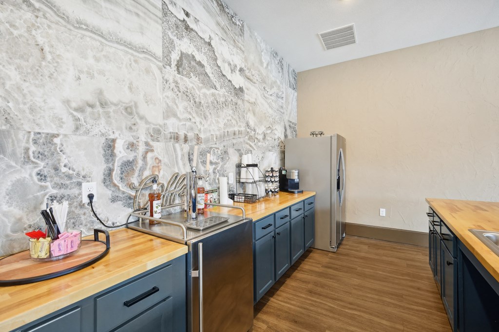 a kitchen with blue cabinets and a sink and a refrigerator