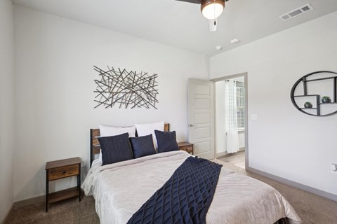 a bedroom with a large bed and a wall art above it