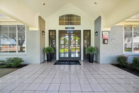 an entrance to a building with doors and windows