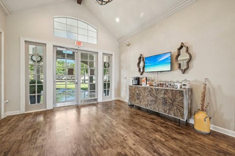the living room of a house with a bar and a door to a patio