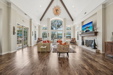 a large living room with a fireplace and a large window