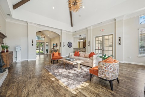 a living room with couches and chairs and a fireplace