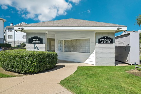 the main center is a white building with a sidewalk and grass