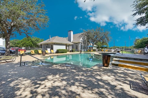 a resort style pool with a building in the background