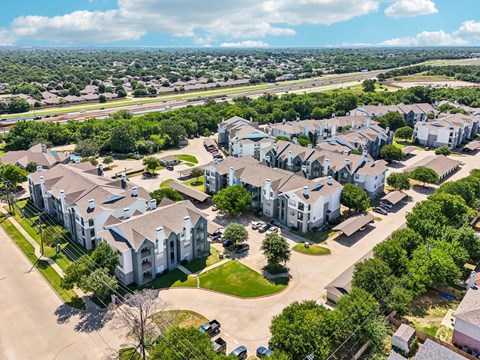 an aerial view of a neighborhood with houses and trees