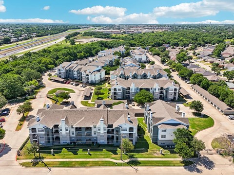 an aerial view of a neighborhood with houses and trees