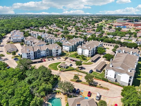 an aerial view of a neighborhood with houses and a pool