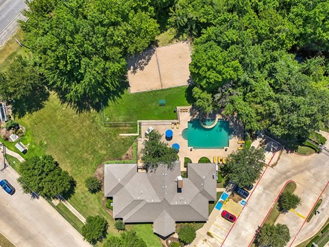 an aerial view of a house with a swimming pool in the yard