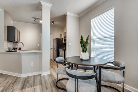 A dining area with a table and chairs.