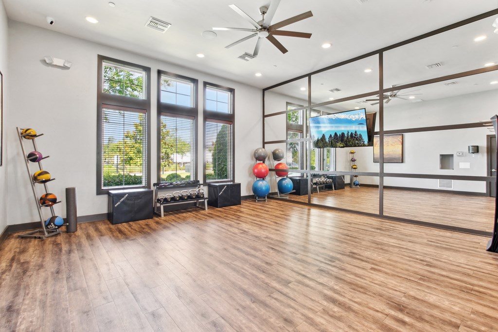 the preserve at ballantyne commons fitness room with hardwood floors and windows