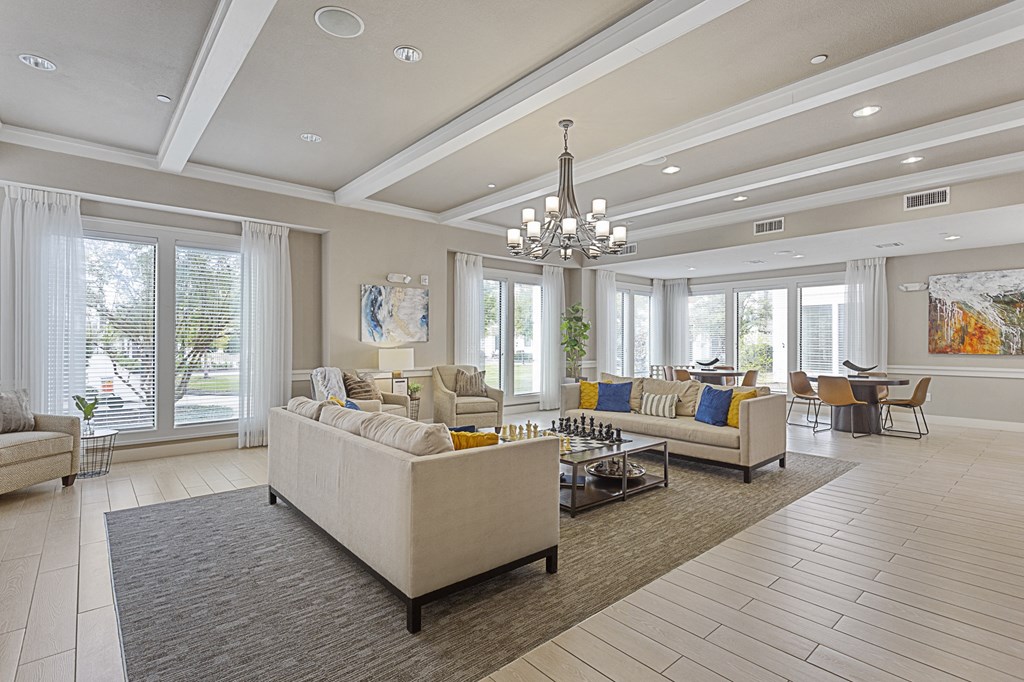 a large living room with couches and chairs and a chandelier