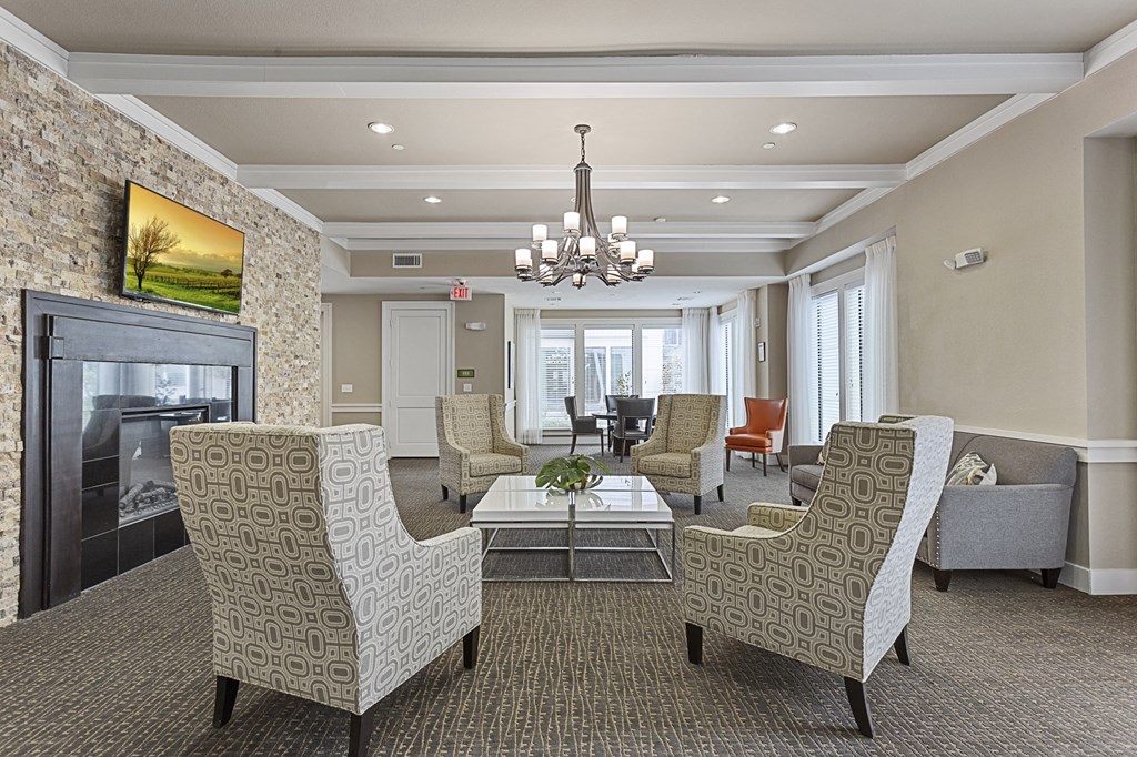a lobby with couches and chairs and a fireplace