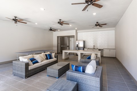 A modern living room with a grey sofa and a white table.
